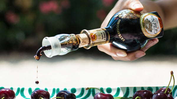 La Cà dal Nôn Aceto Balsamico Tradizionale di Modena DOP Extravecchio being poured over fresh cherries