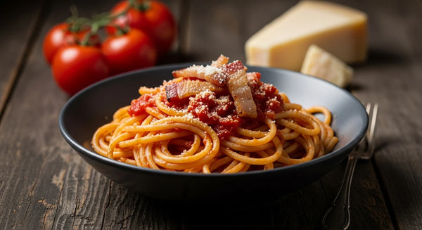 A bowl of bucatini all'Amatriciana in tomato sauce topped with crispy guanciale and grated Pecorino.